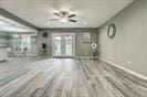 3889 County Road 155, Alvin, TX 77511 - unfurnished living room with wood finished floors and a ceiling fan