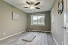 3889 County Road 155, Alvin, TX 77511 - unfurnished bedroom with baseboards and wood finished floors