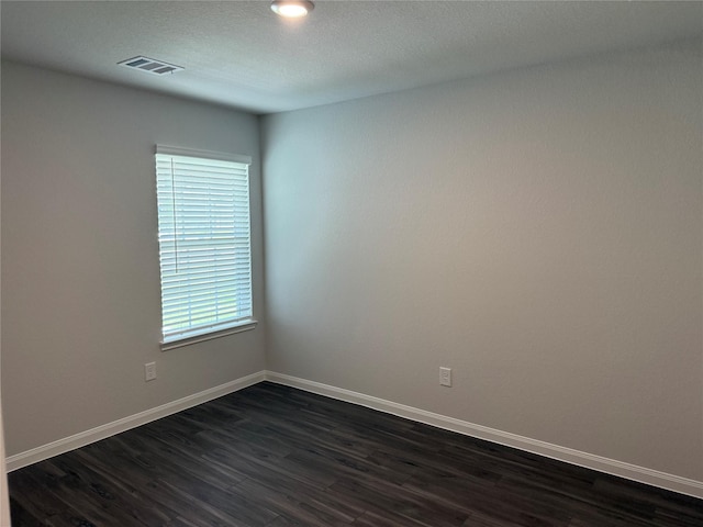 13317 Burbot Dr, Conroe, TX 77384 - empty room featuring dark wood-style flooring and baseboards