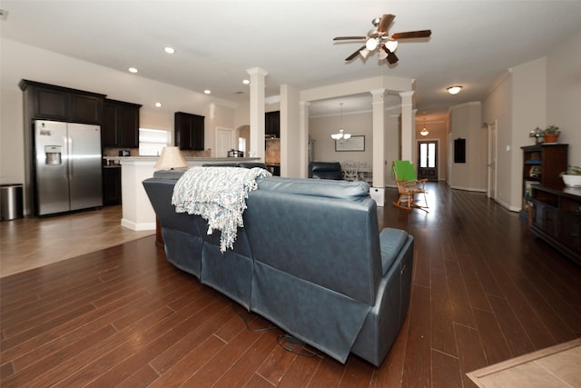 28407 Kinglet Pines Dr, Katy, TX 77494 - living area with decorative columns, ceiling fan, and dark wood-type flooring
