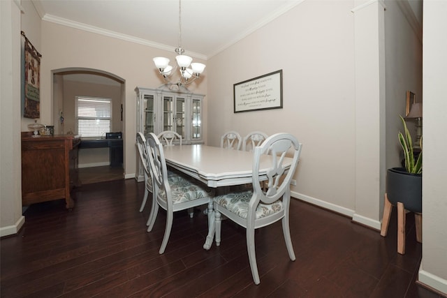 28407 Kinglet Pines Dr, Katy, TX 77494 - dining area featuring a chandelier, crown molding, arched walkways, and dark wood-style flooring