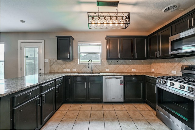 1927 Vermillion View St, Fresno, TX 77545 - kitchen featuring appliances with stainless steel finishes, stone countertops, and backsplash