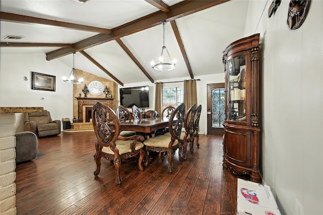 319 Shady Glade Dr, Houston, TX 77090 - dining room featuring a chandelier, dark wood finished floors, and a fireplace with raised hearth
