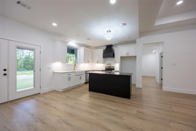 51 V Allen Ln, Coldspring, TX 77331 - kitchen featuring premium range hood, white cabinetry, light wood finished floors, a center island, and recessed lighting