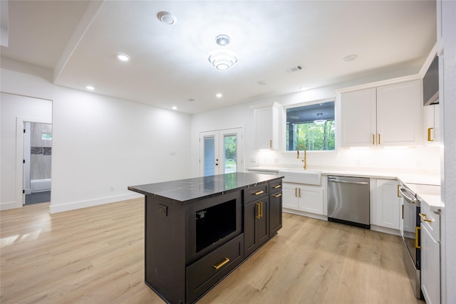 51 V Allen Ln, Coldspring, TX 77331 - kitchen with stainless steel appliances, white cabinets, light wood finished floors, and recessed lighting