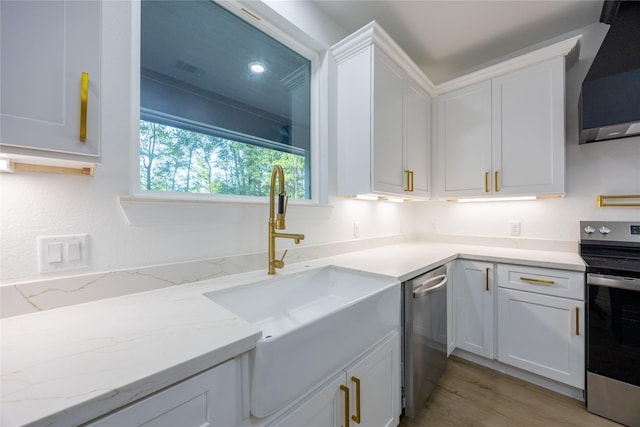 51 V Allen Ln, Coldspring, TX 77331 - kitchen featuring stainless steel appliances, white cabinetry, exhaust hood, light stone counters, and light wood-style floors