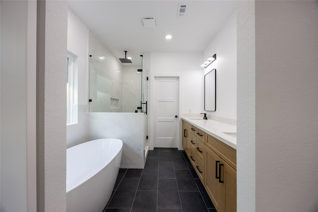 51 V Allen Ln, Coldspring, TX 77331 - bathroom with a marble finish shower, double vanity, a freestanding tub, and tile patterned floors