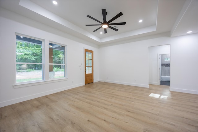 51 V Allen Ln, Coldspring, TX 77331 - empty room featuring a tray ceiling, light wood-type flooring, ceiling fan, and recessed lighting