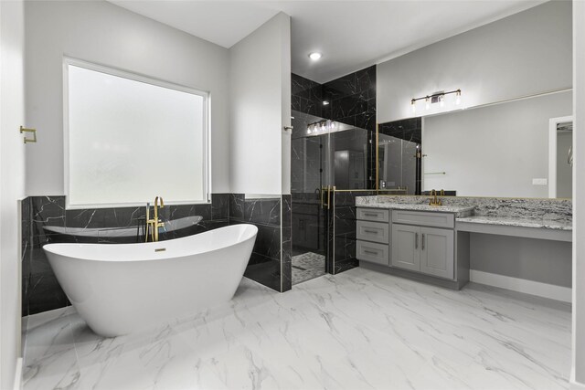 210 Hogan Ln, Hempstead, TX 77445 - bathroom featuring a stall shower, vanity, tile walls, a soaking tub, and marble finish flooring