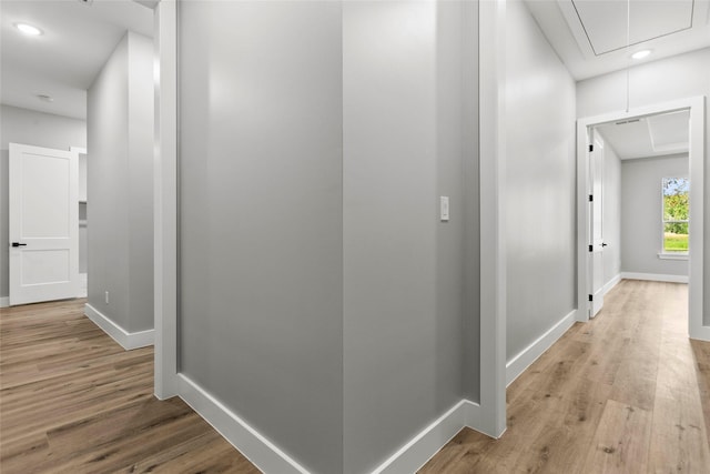 210 Hogan Ln, Hempstead, TX 77445 - hall featuring attic access, wood finished floors, and recessed lighting