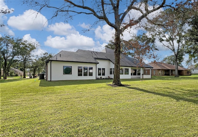 210 Hogan Ln, Hempstead, TX 77445 - back of property with a lawn and stucco siding