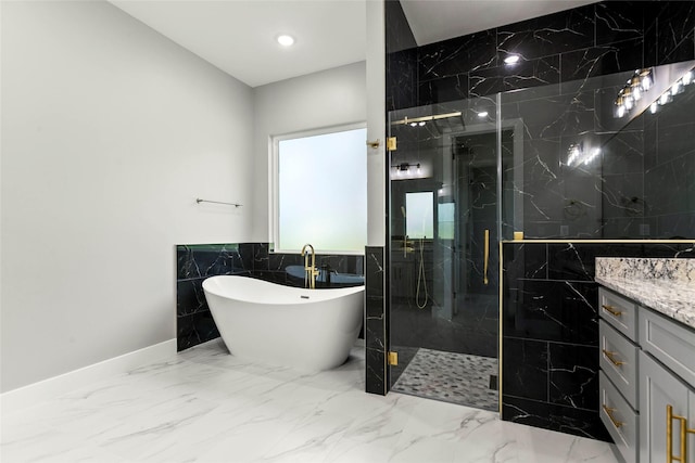 210 Hogan Ln, Hempstead, TX 77445 - bathroom featuring tile walls, a marble finish shower, a freestanding tub, vanity, and marble tiled floors
