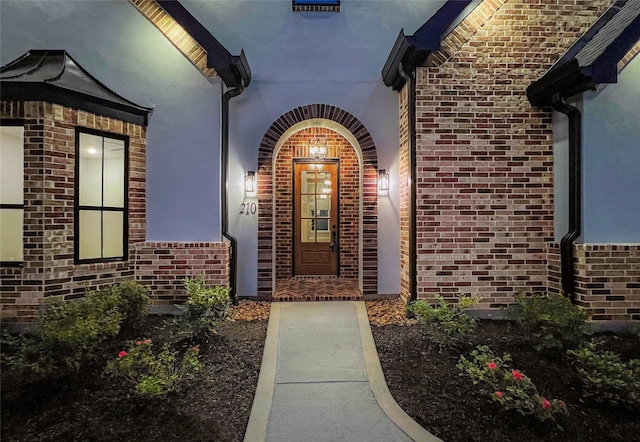 210 Hogan Ln, Hempstead, TX 77445 - doorway to property featuring stucco siding and brick siding