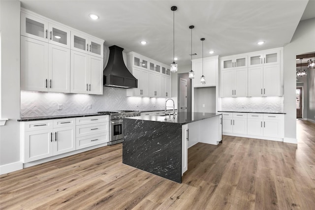 210 Hogan Ln, Hempstead, TX 77445 - kitchen featuring high end stainless steel range, custom range hood, dark countertops, light wood-style floors, and recessed lighting