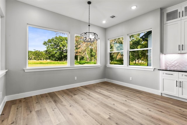 210 Hogan Ln, Hempstead, TX 77445 - unfurnished dining area featuring healthy amount of natural light, a chandelier, light wood-style flooring, and recessed lighting