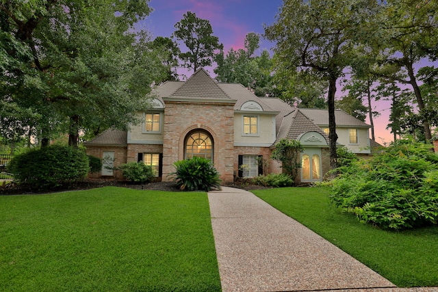 9327 Tranquil Park Dr, Spring, TX 77379 - french country inspired facade featuring brick siding and a yard
