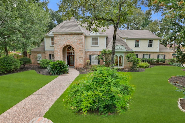 9327 Tranquil Park Dr, Spring, TX 77379 - view of front of house featuring a front lawn, brick siding, and stucco siding