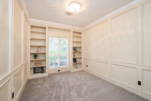 9327 Tranquil Park Dr, Spring, TX 77379 - spare room with a decorative wall, built in shelves, crown molding, and carpet flooring
