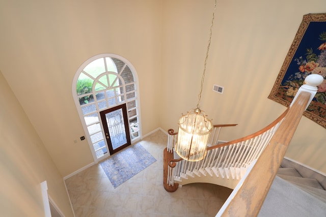 9327 Tranquil Park Dr, Spring, TX 77379 - tiled foyer with french doors, a chandelier, stairs, and a high ceiling