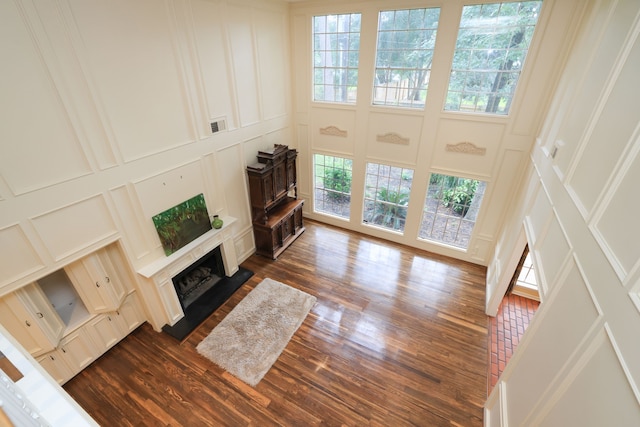 9327 Tranquil Park Dr, Spring, TX 77379 - living area with a decorative wall, dark wood-type flooring, and a fireplace