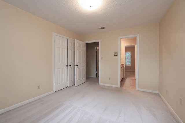 9327 Tranquil Park Dr, Spring, TX 77379 - unfurnished bedroom featuring a textured ceiling, light colored carpet, and a closet