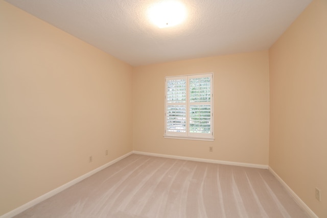 9327 Tranquil Park Dr, Spring, TX 77379 - spare room with light colored carpet and a textured ceiling