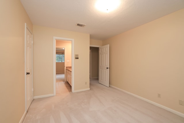 9327 Tranquil Park Dr, Spring, TX 77379 - unfurnished bedroom featuring light colored carpet and a textured ceiling