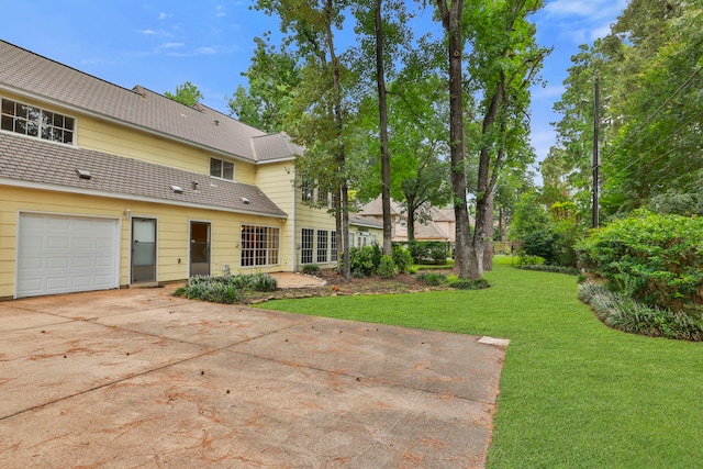 9327 Tranquil Park Dr, Spring, TX 77379 - view of grassy yard featuring driveway and a garage