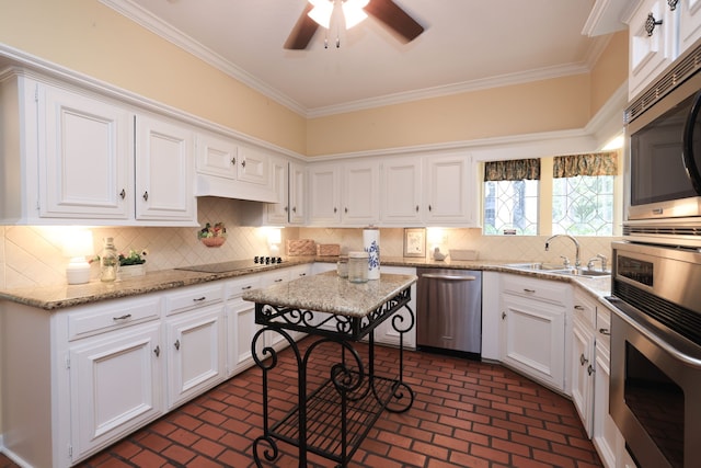 9327 Tranquil Park Dr, Spring, TX 77379 - kitchen featuring appliances with stainless steel finishes, brick flooring, white cabinets, crown molding, and a ceiling fan