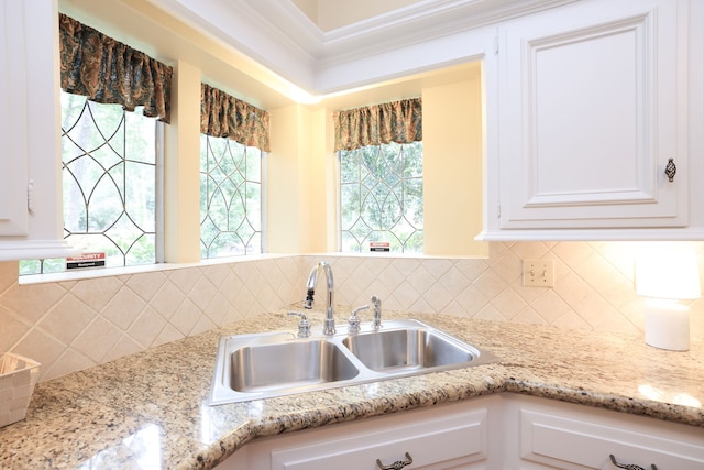 9327 Tranquil Park Dr, Spring, TX 77379 - kitchen featuring white cabinetry, backsplash, and light stone countertops