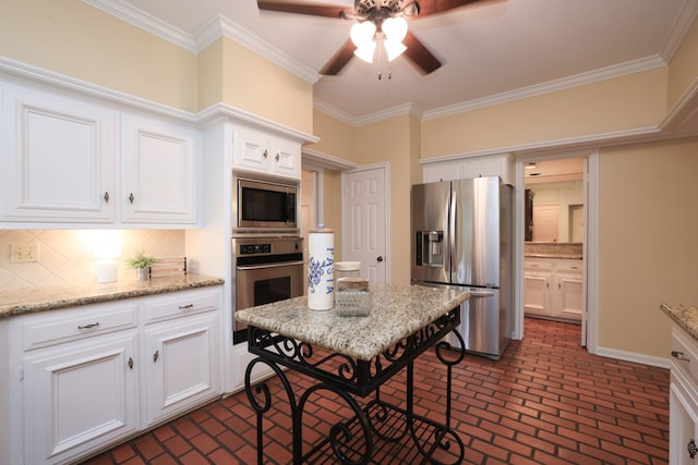 9327 Tranquil Park Dr, Spring, TX 77379 - kitchen featuring stainless steel appliances, brick flooring, a ceiling fan, backsplash, and white cabinets