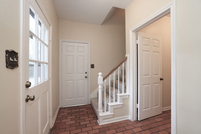 9327 Tranquil Park Dr, Spring, TX 77379 - entrance foyer with brick patterned floors and stairway