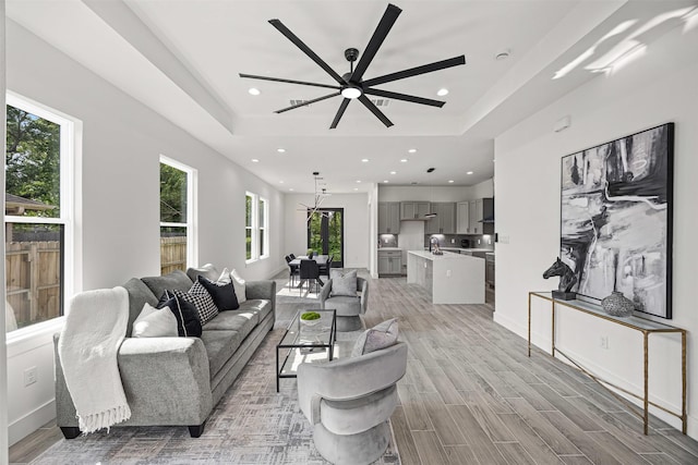 316 E Oakdale St, Dayton, TX 77535 - living room with recessed lighting, a raised ceiling, light wood-style floors, and a ceiling fan