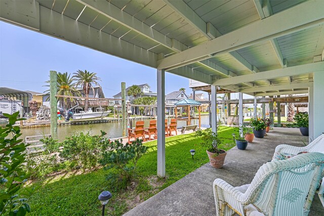 34 Tarpon Ln, Freeport, TX 77541 - view of patio / terrace featuring a water view, boat lift, a boat dock, and a residential view