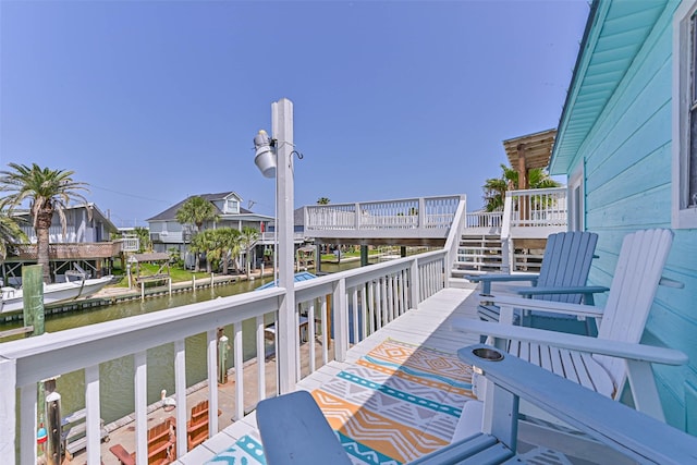 34 Tarpon Ln, Freeport, TX 77541 - balcony featuring a deck with water view and stairway