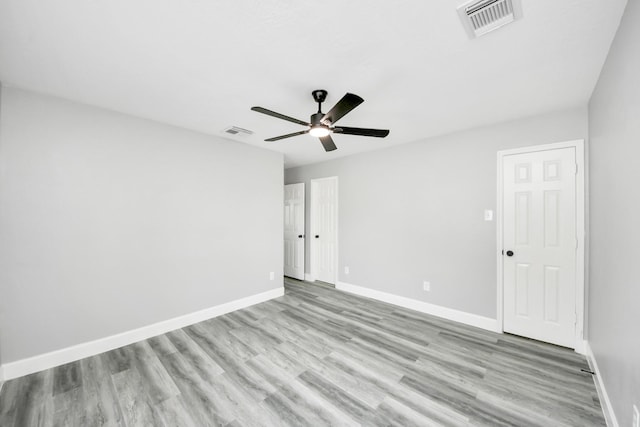 7427 Oakwood Canyon Dr, Cypress, TX 77433 - empty room with light wood-style flooring and a ceiling fan