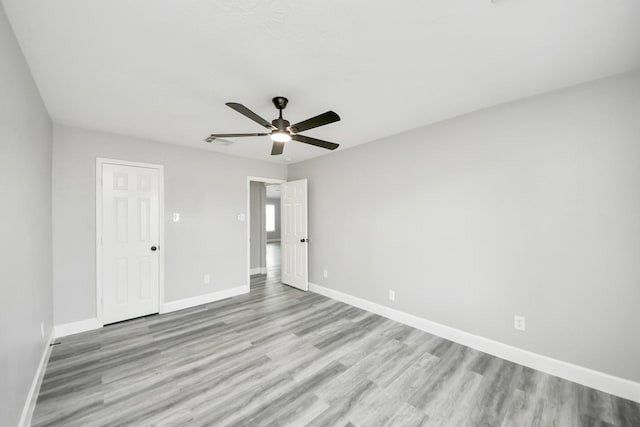 7427 Oakwood Canyon Dr, Cypress, TX 77433 - unfurnished bedroom with light wood-style floors and ceiling fan
