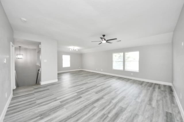 7427 Oakwood Canyon Dr, Cypress, TX 77433 - unfurnished living room with wood finished floors and a ceiling fan