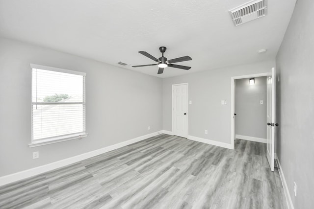 7427 Oakwood Canyon Dr, Cypress, TX 77433 - unfurnished bedroom featuring light wood-style flooring and ceiling fan