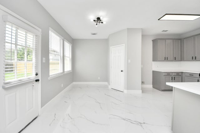 7427 Oakwood Canyon Dr, Cypress, TX 77433 - unfurnished dining area featuring baseboards and light marble finish floors