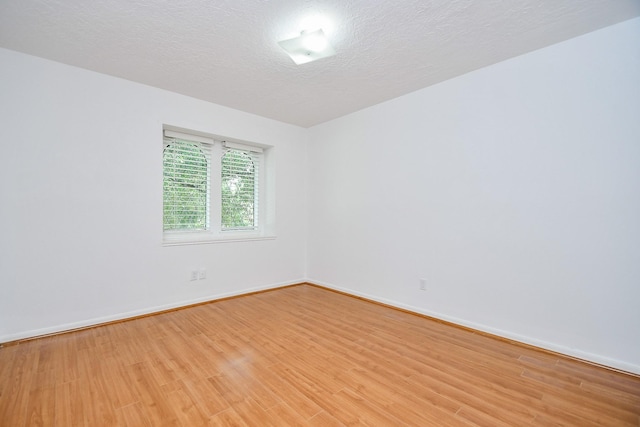 2622 Williams Grant St, Sugar Land, TX 77479 - empty room with light wood-style floors and a textured ceiling