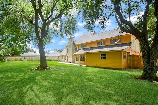 2622 Williams Grant St, Sugar Land, TX 77479 - rear view of house with a fenced backyard and a chimney