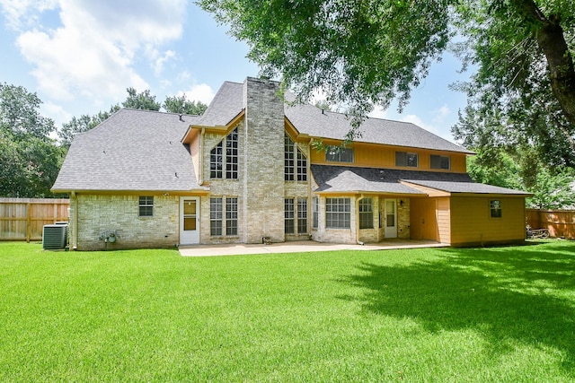 2622 Williams Grant St, Sugar Land, TX 77479 - back of property featuring a patio, a chimney, stone siding, and a shingled roof