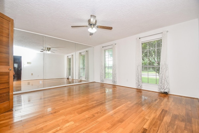 2622 Williams Grant St, Sugar Land, TX 77479 - empty room with wood finished floors, a textured ceiling, and a ceiling fan