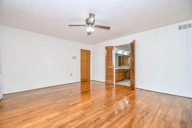 2622 Williams Grant St, Sugar Land, TX 77479 - unfurnished room with ceiling fan, light wood-style floors, and a textured ceiling