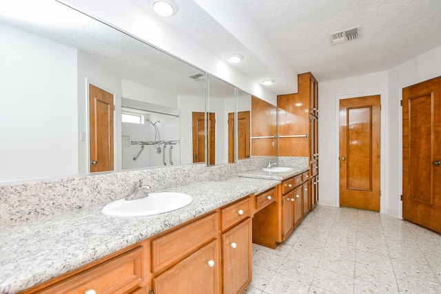 2622 Williams Grant St, Sugar Land, TX 77479 - full bathroom featuring double vanity, a closet, a textured ceiling, and recessed lighting
