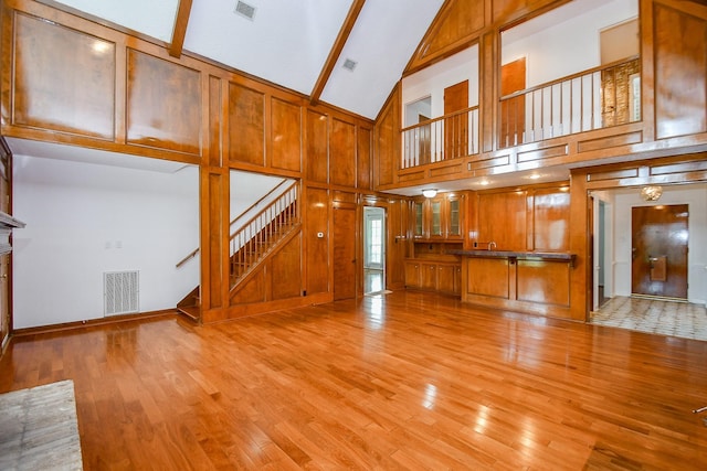 2622 Williams Grant St, Sugar Land, TX 77479 - unfurnished living room featuring stairway, light wood-style floors, high vaulted ceiling, and beam ceiling