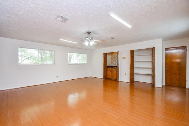 2622 Williams Grant St, Sugar Land, TX 77479 - spare room with a textured ceiling, ceiling fan, and light wood-style flooring