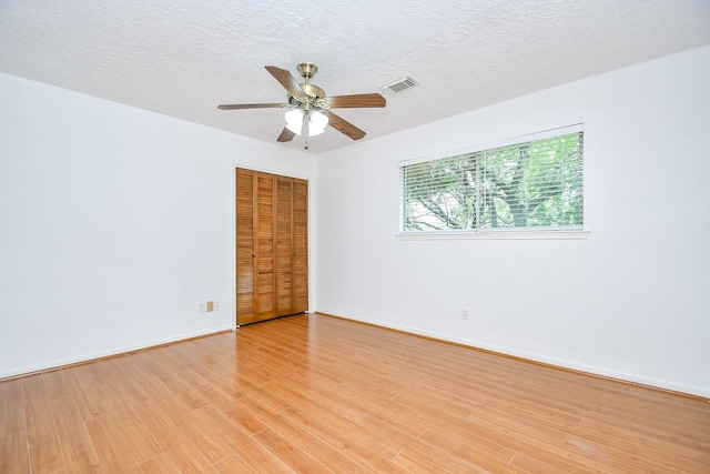 2622 Williams Grant St, Sugar Land, TX 77479 - spare room with light wood-style floors, ceiling fan, and a textured ceiling