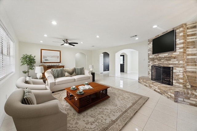 4530 T C Jester Blvd, Houston, TX 77018 - living area with light tile patterned floors, ceiling fan, a fireplace, recessed lighting, and arched walkways